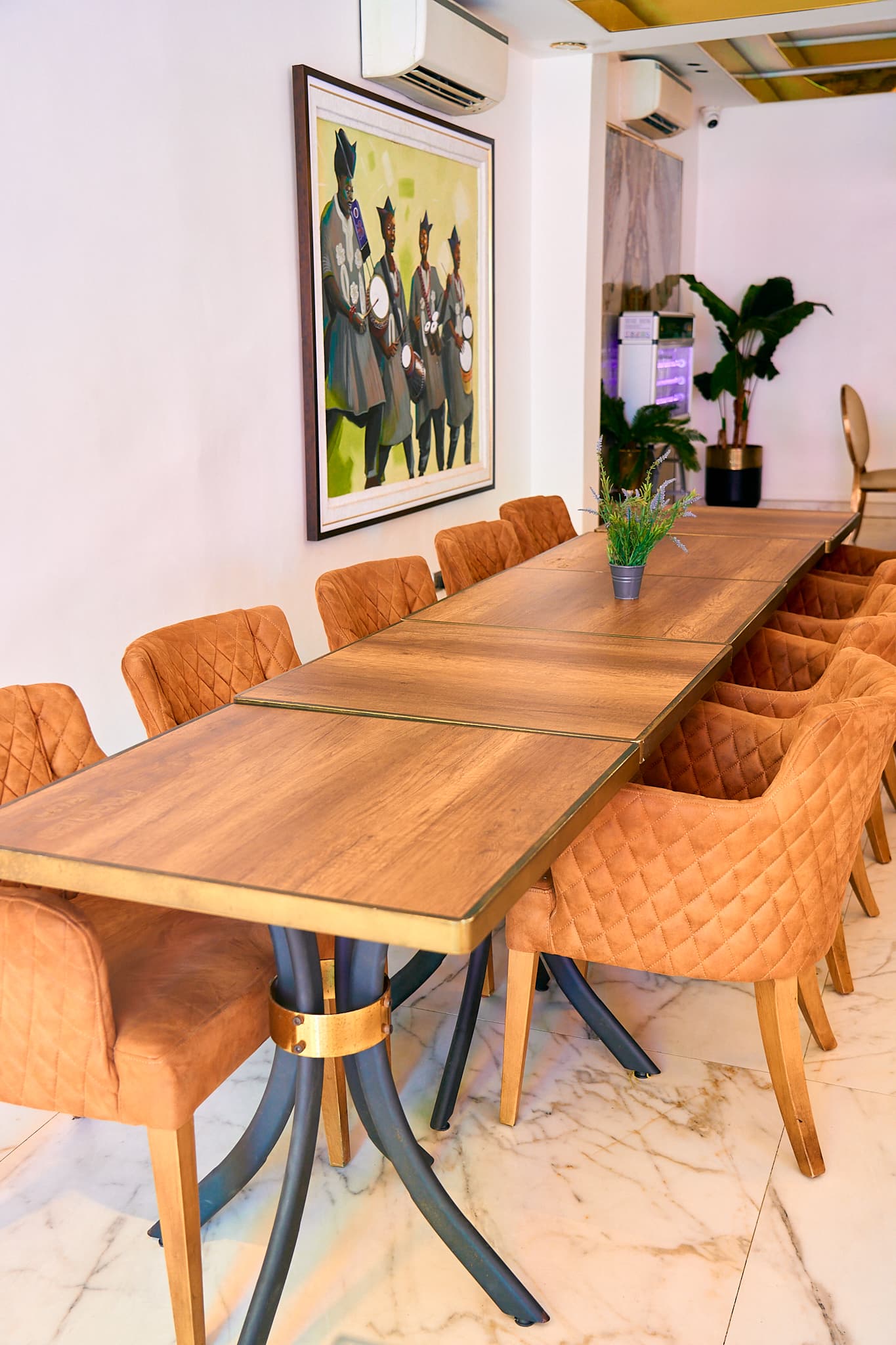 Long dining table with orange chairs