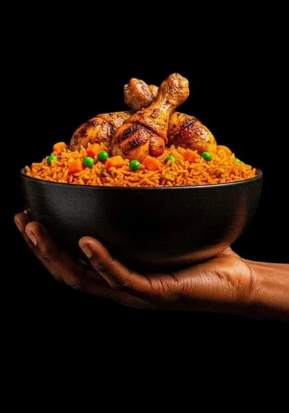 A hand holding a bowl of jollof rice with grilled chicken